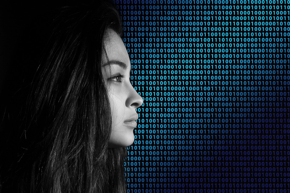 woman in profile with binary in background