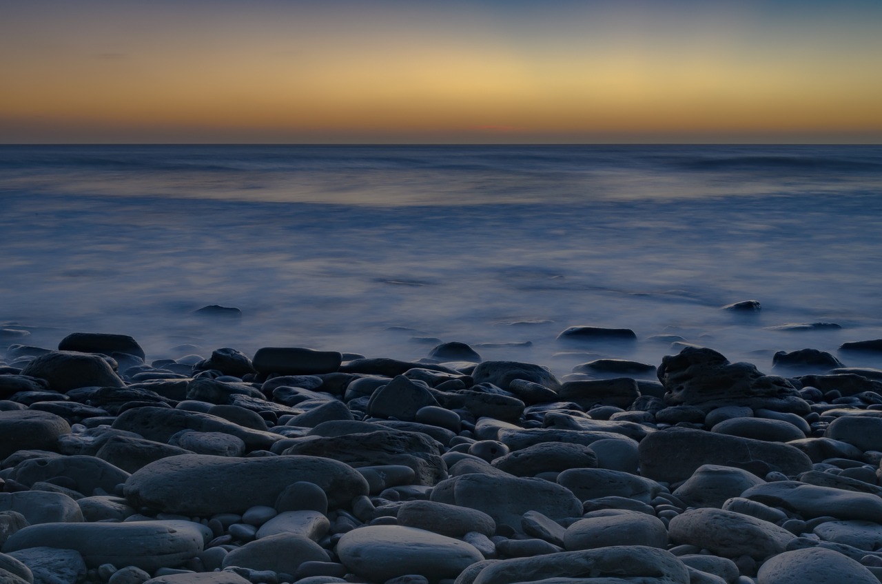 rocks by the seaside at sundown